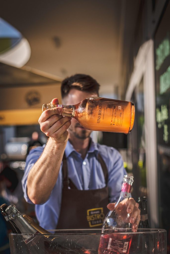 Elegant whiskey service by a waiter at a modern bachelor party
