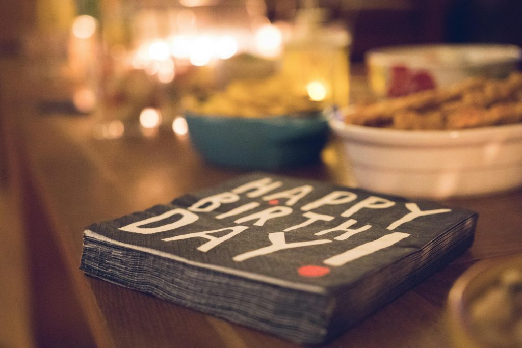 Close-up of a festive birthday table setup with snacks and decor.
